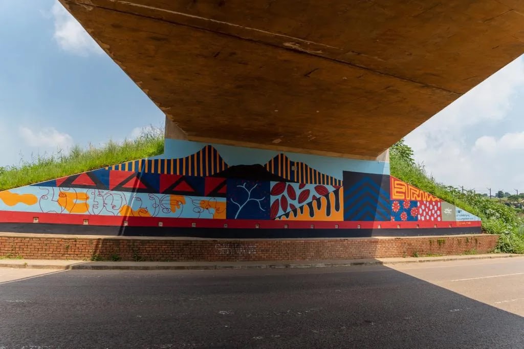 A large-scale community mural painted by Meg Moore